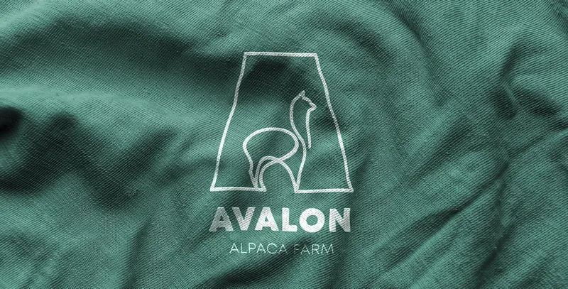 Avalon Alpaca Farm logo embroidered on green fabric